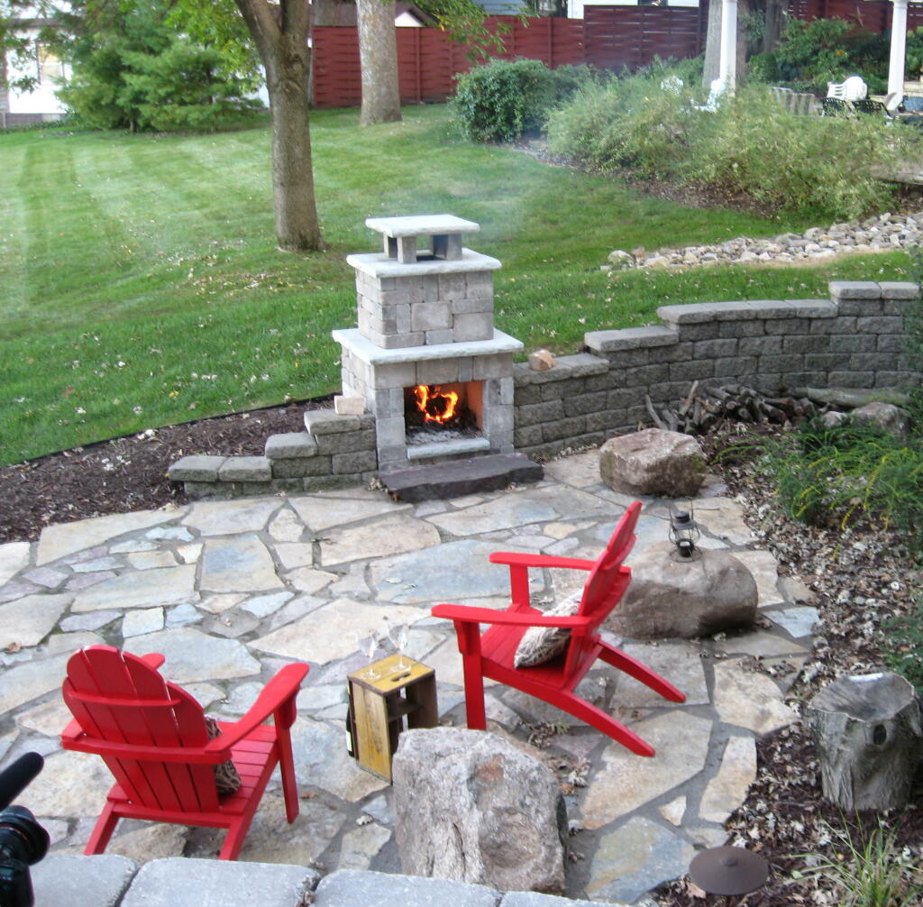 backyard stone patio and fireplace by Sequoia Landscape