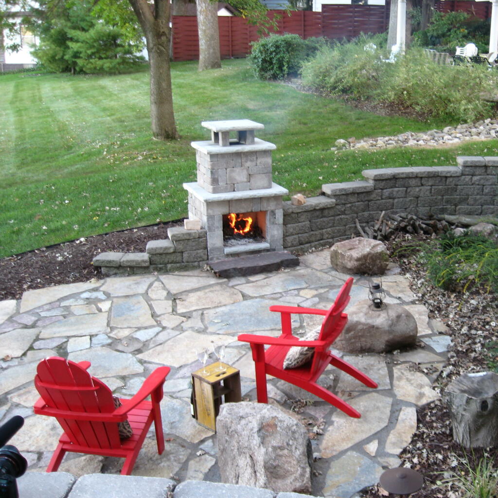 entertaining in your backyard with patio, fireplace, retaining wall