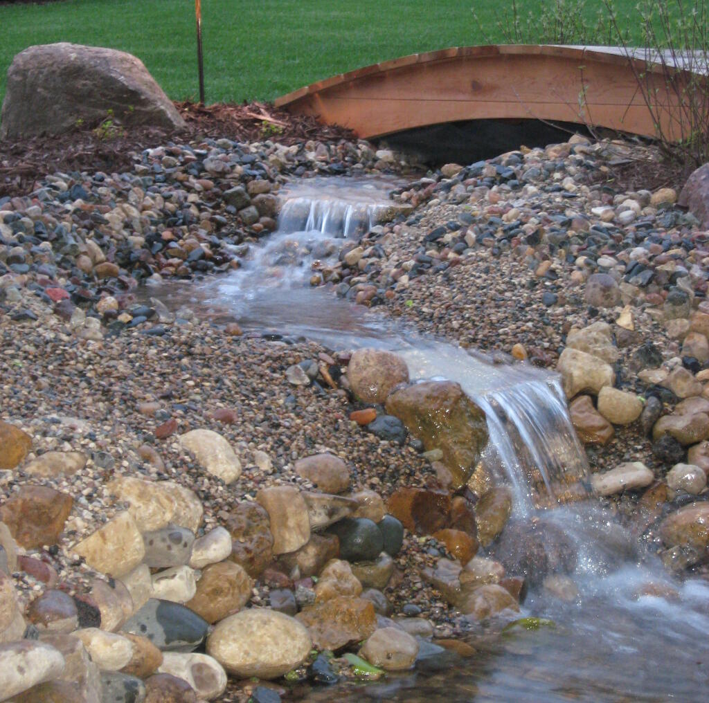 rock river bed with bridge by Sequoia Landscape